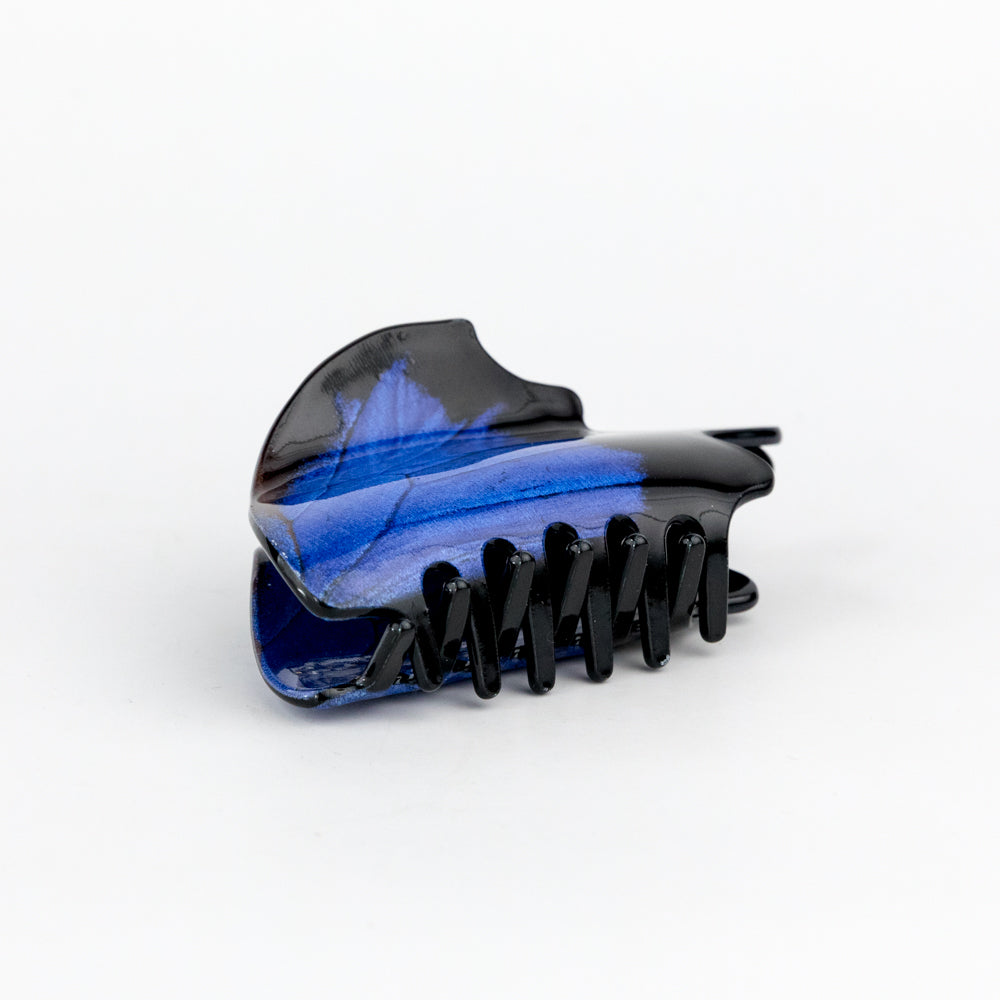 Blue and black hair clip on a white background
