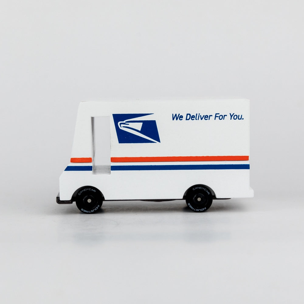 Model toy of a postal truck with USPS logo and 'We Deliver For You.' text on a white background