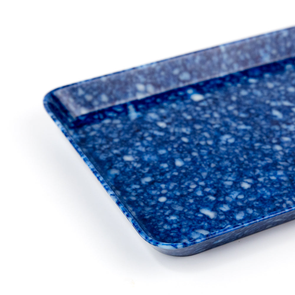 Blue speckled rectangular tray on a white background
