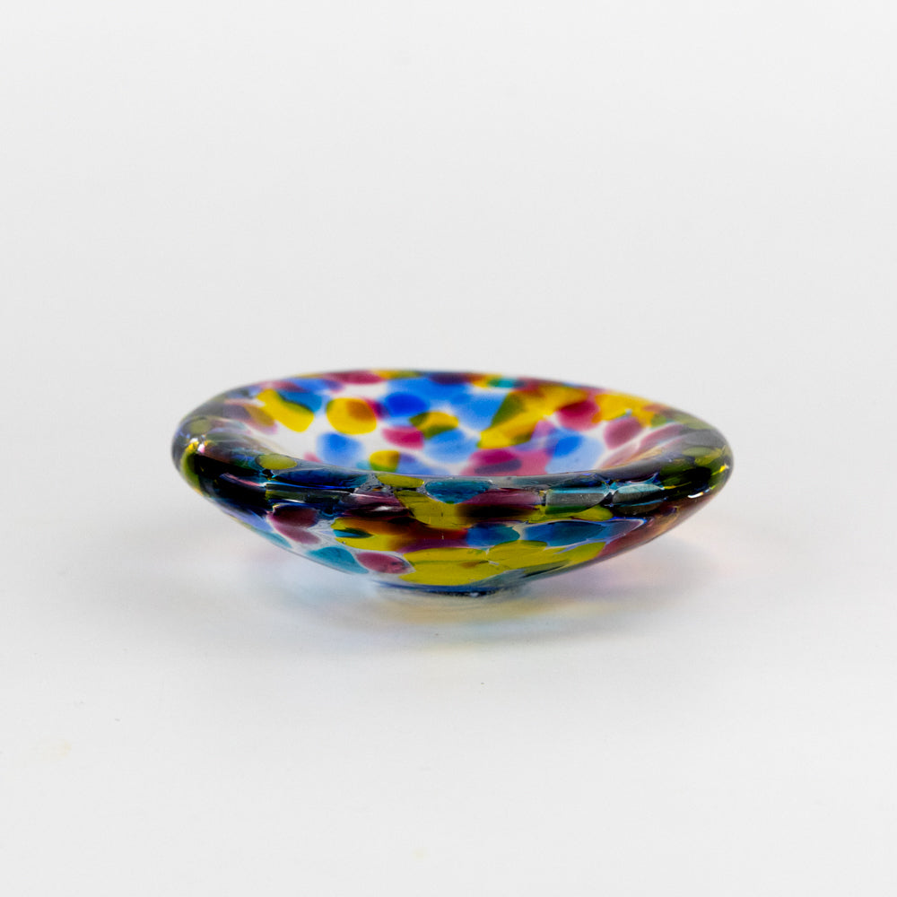 Multicolored glass dish on a white background