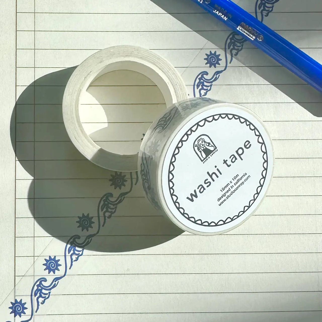 Roll of washi tape with decorative wave design on a white background