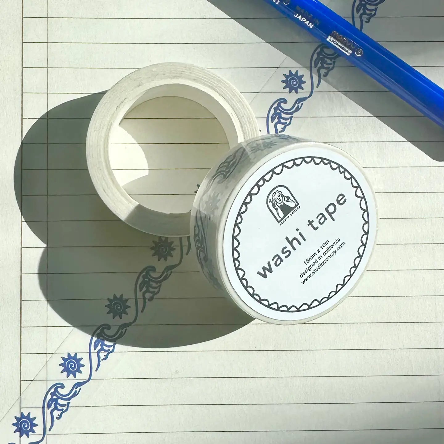 Two rolls of washi tape on a lined paper background