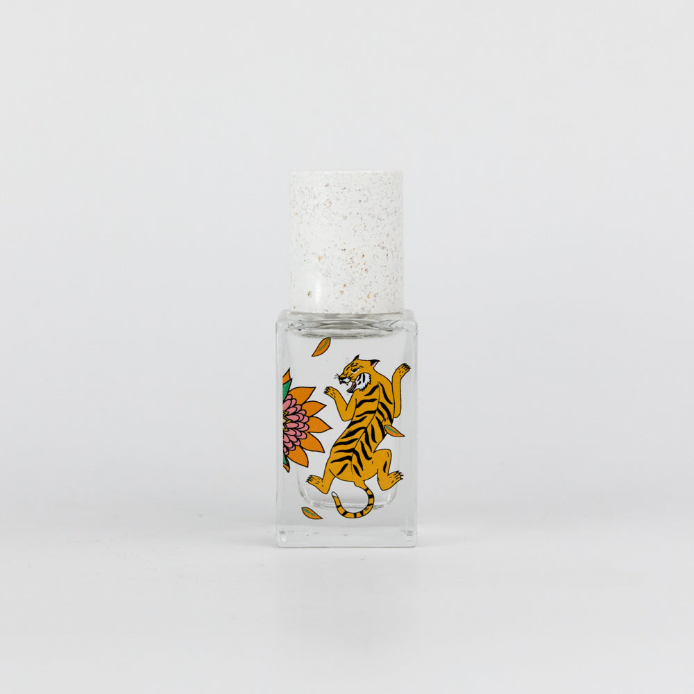 Small glass bottle with a tiger design on a white background