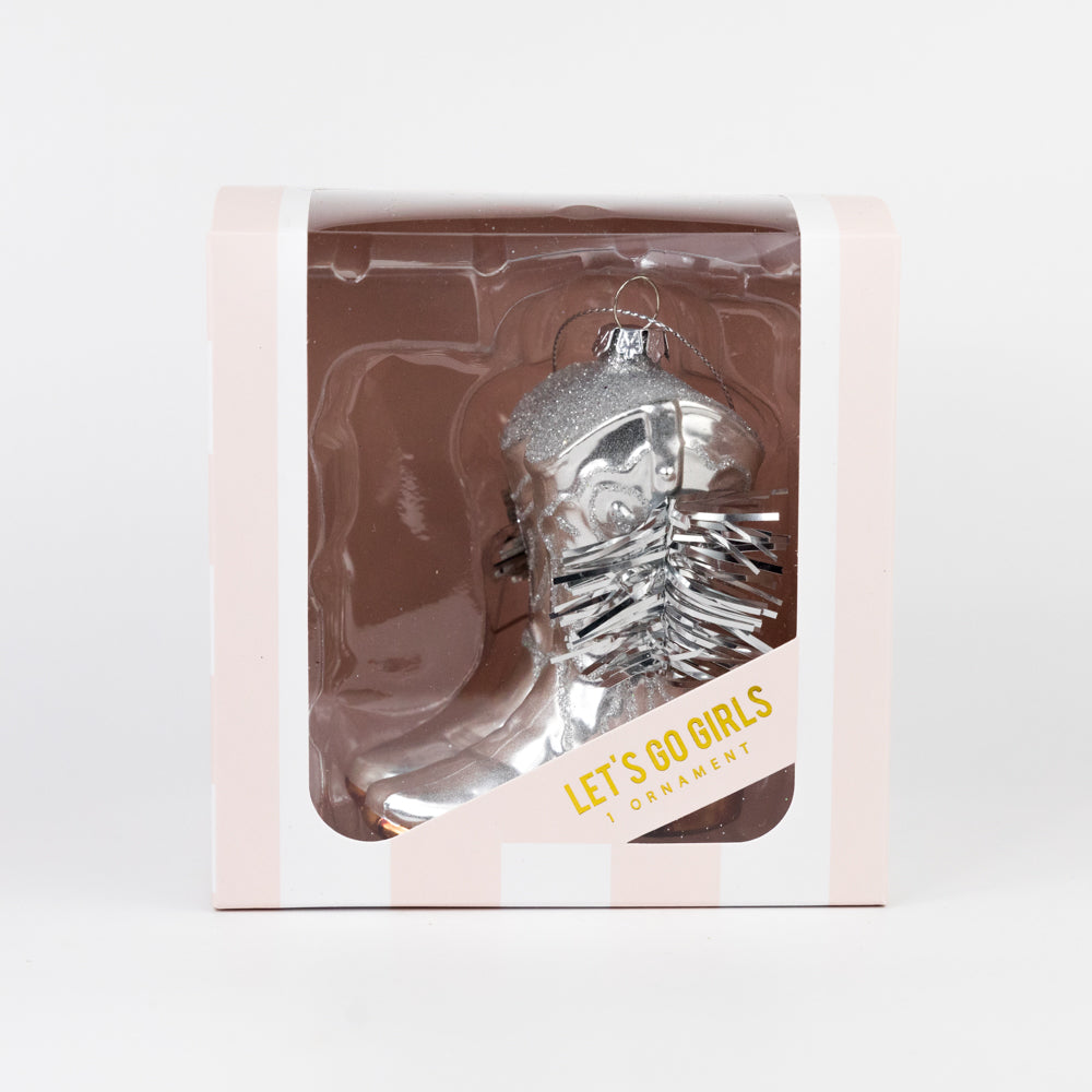 Decorative glass ornament with glittery top in a clear box on a white background