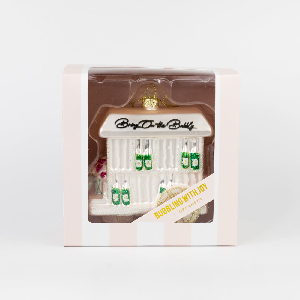 Boxed Christmas tree decoration of a champagne cart with with 'Bring on the Bubbly' text on a white background