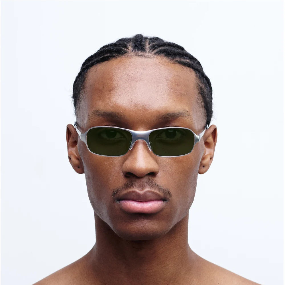 Person wearing sunglasses with a plain background