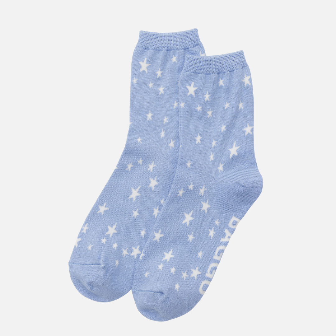 Light blue socks with white star patterns on a light gray background
