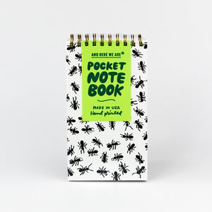 Pocket spiral notebook with ant pattern and green label on a white background