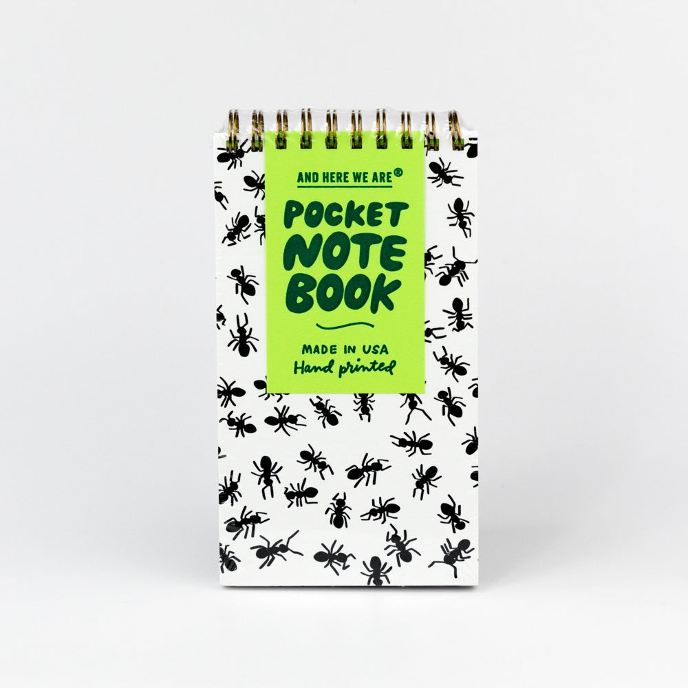 Pocket spiral notebook with ant pattern and green label on a white background