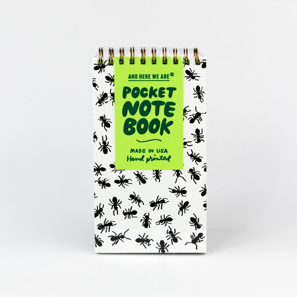 Pocket spiral notebook with ant pattern and green label on a white background