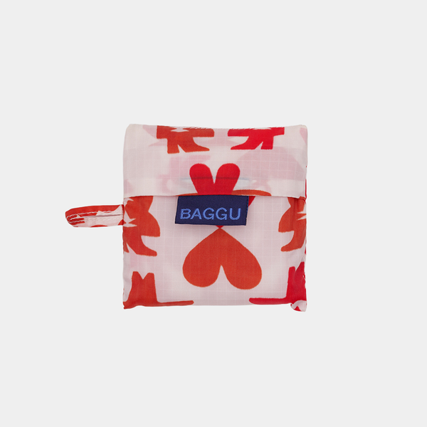 Small pouch with red heart pattern and blue 'BAGGU' tag on a white background