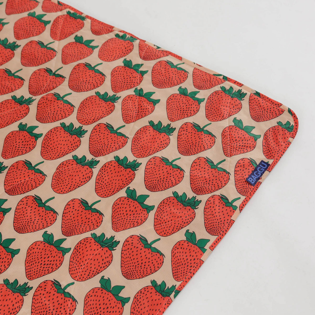Fabric with strawberry pattern on a beige background