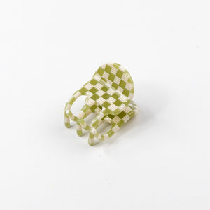 Green and white checkered hair claw on a white background
