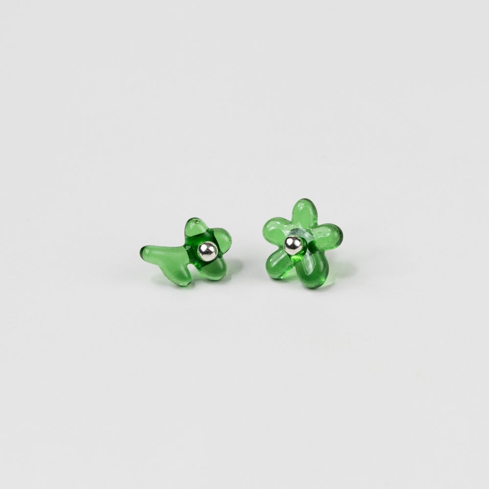Pair of green flower-shaped earrings on a light gray background