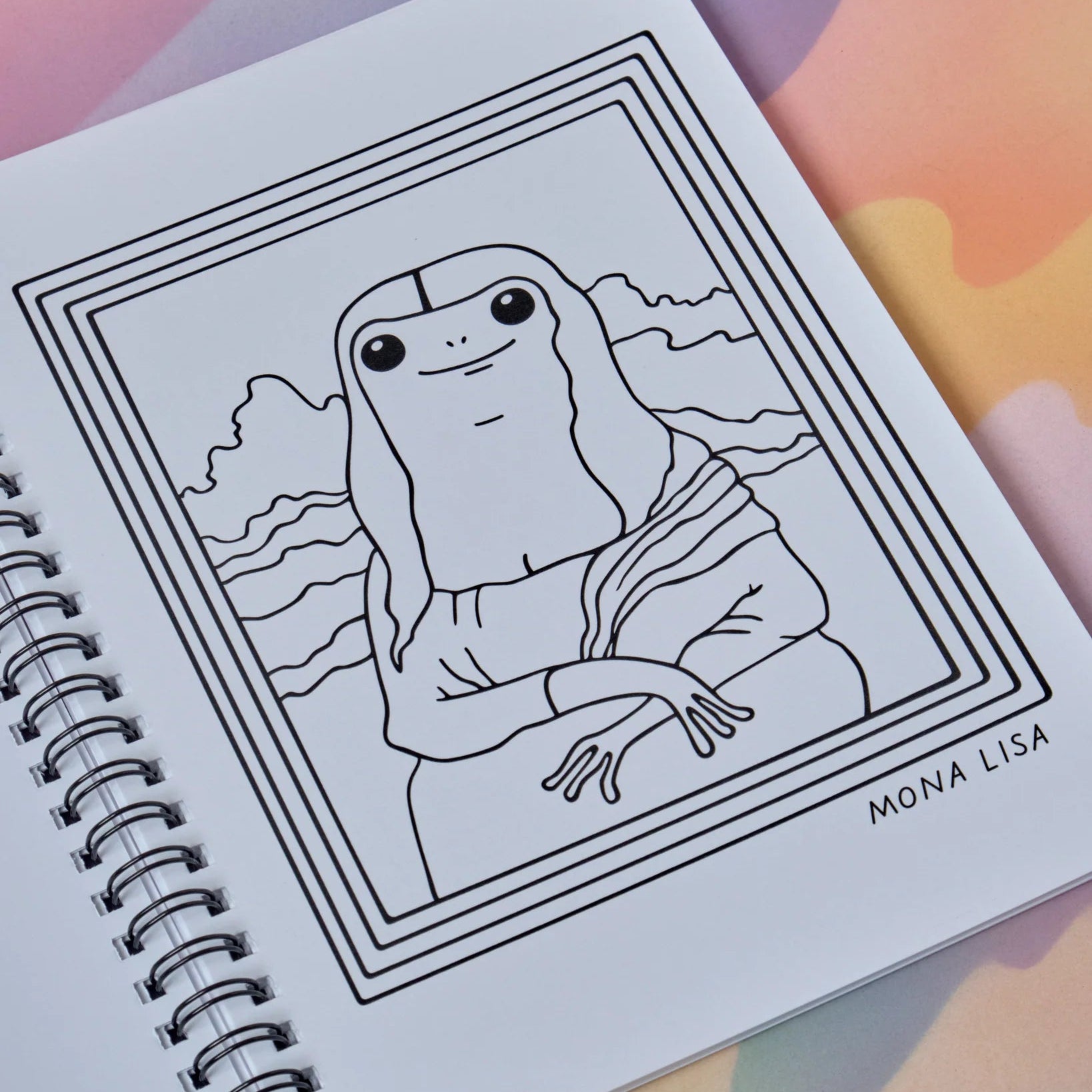 Spiral-bound notebook with a line drawing of the Mona Lisa on a colorful background