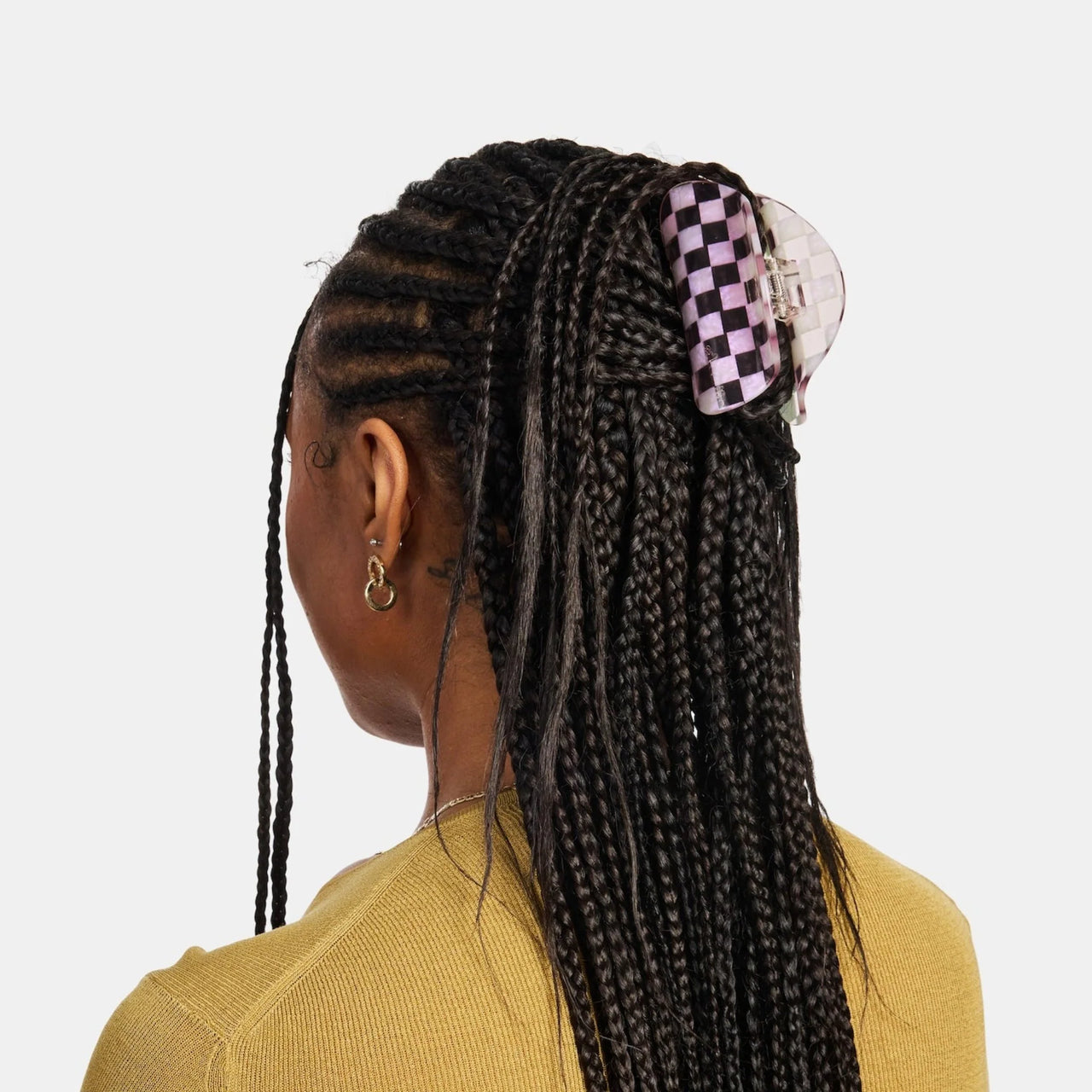 Pink hair clip on a light gray background