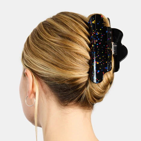 Black hair clip with colorful speckles on a white background