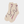 Beige socks with pink bow design on a light gray background