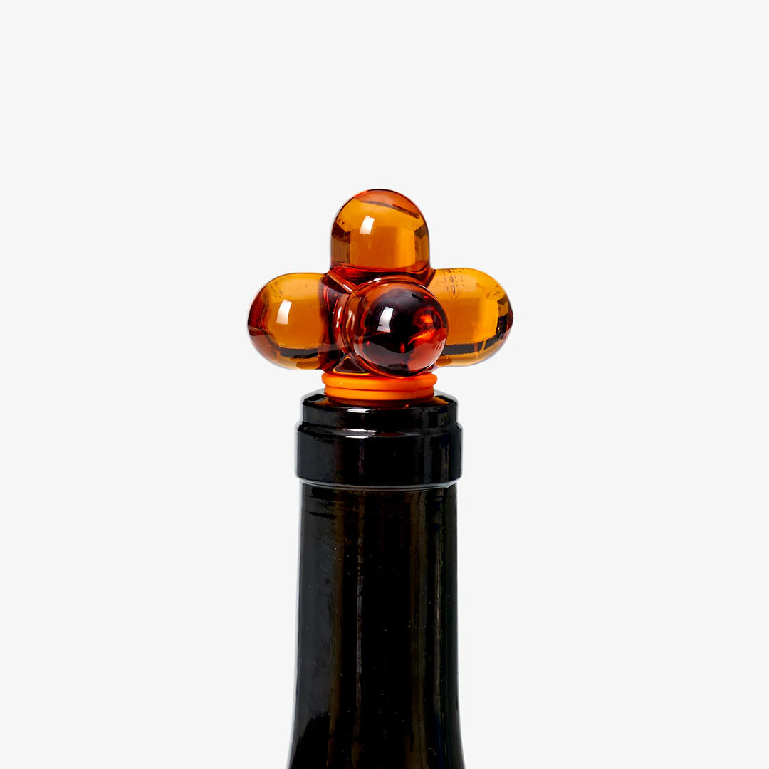 Amber glass bauble bottle stopper 
on a white background