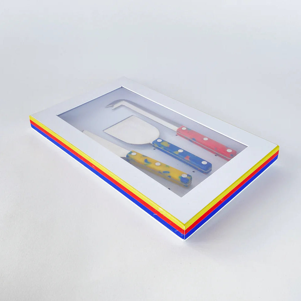 Colorful kitchen utensils in a box on a white background