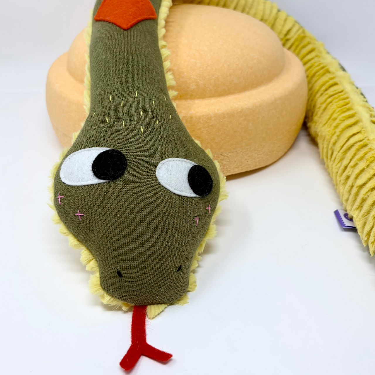 Plush snake toy with a white background