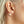 Close-up of an ear wearing a colorful bubble earring .