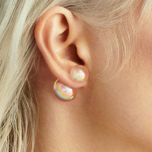 Close-up of an ear wearing a colorful bubble earring .