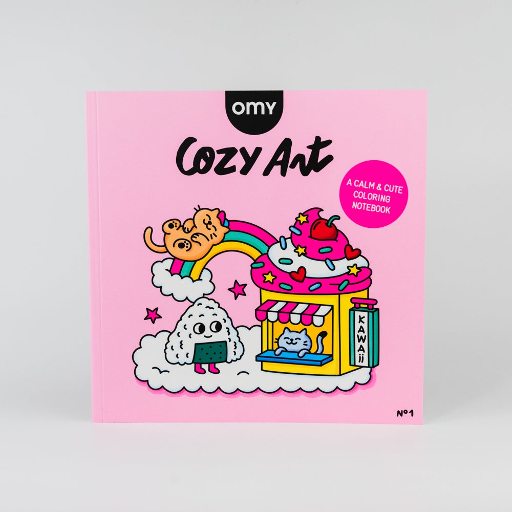 Coloring notebook titled 'Cozy Art' by OMY with cartoon illustrations on a pink cover.