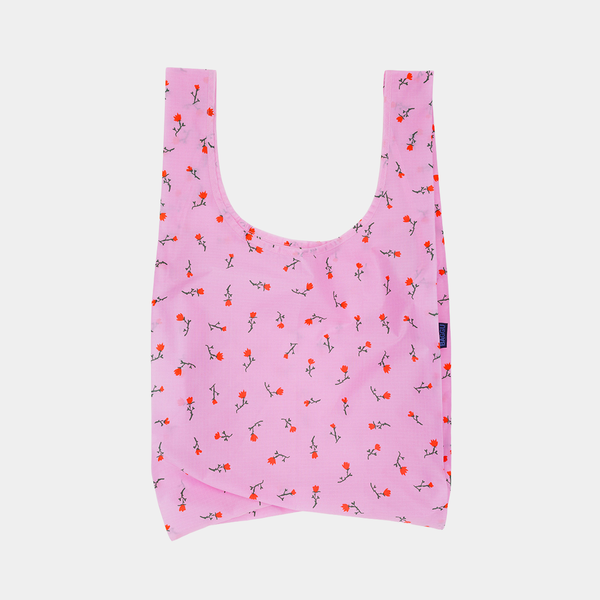 Pink reusable bag with floral pattern on a light gray background