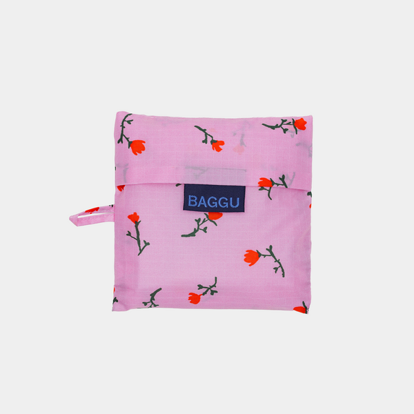 Pink reusable bag with floral pattern and 'BAGGU' logo on a white background
