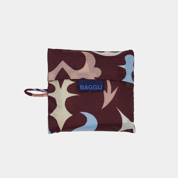 Folded fabric pouch with a pattern and 'BAGGU' logo on a light gray background