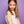 Young girl with colorful temporary tattoos on her arm against a purple background