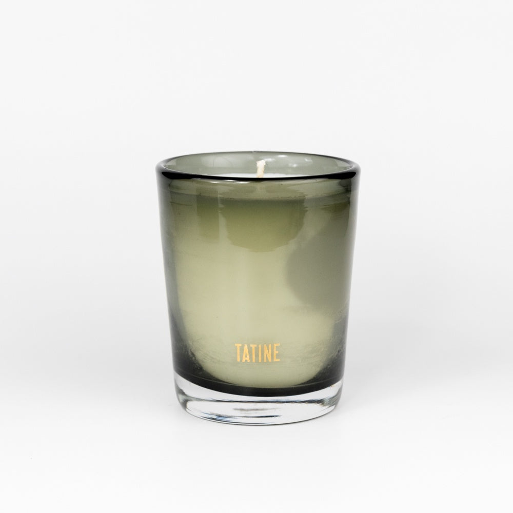 smoky glass jar candle with "Tatine" in gold foil lettering on a white background