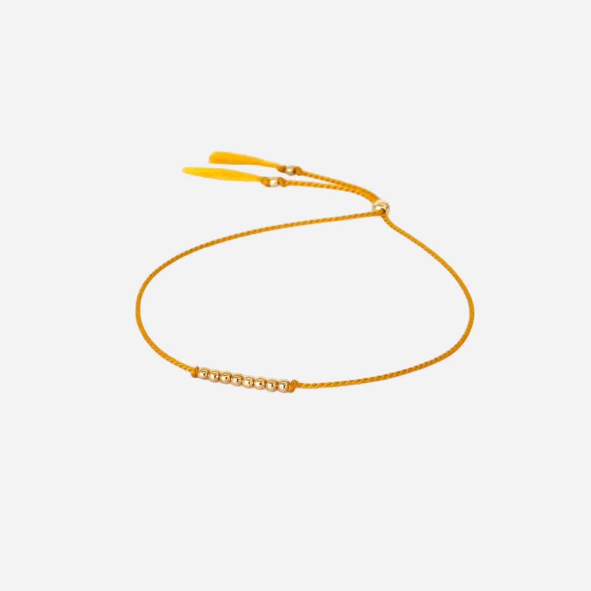 White card with gold text and a yellow bracelet on a white background