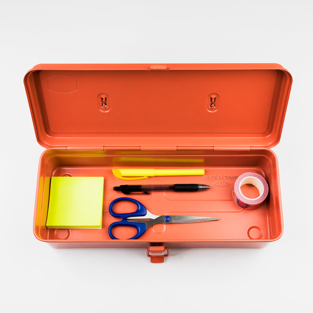 Orange toolbox with stationery items including scissors, pens, and tape on a white background