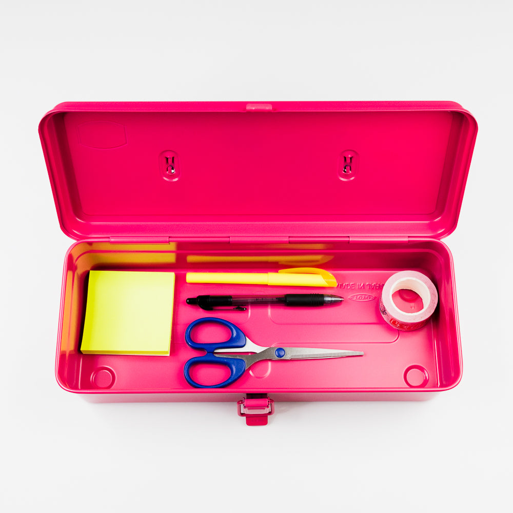 Pink toolbox containing stationery items on a white background