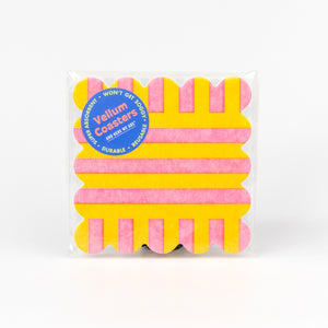 Pack of pink and yellow coasters with a visible brand label on a white background