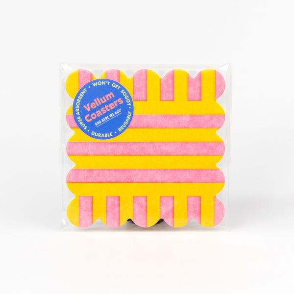 Pack of pink and yellow coasters with a visible brand label on a white background