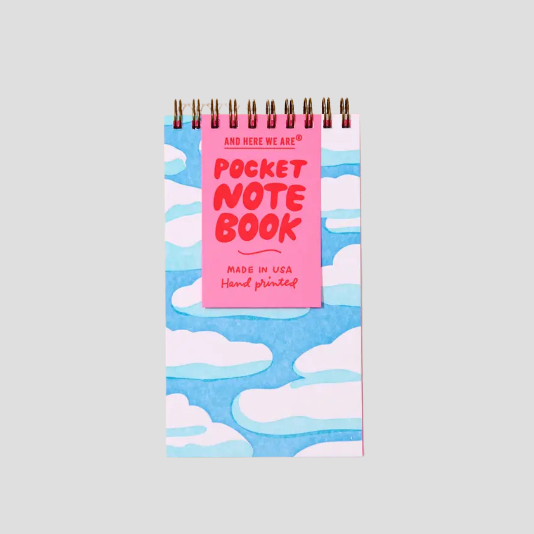 Pocket notebook with cloud pattern and pink label on a light gray background