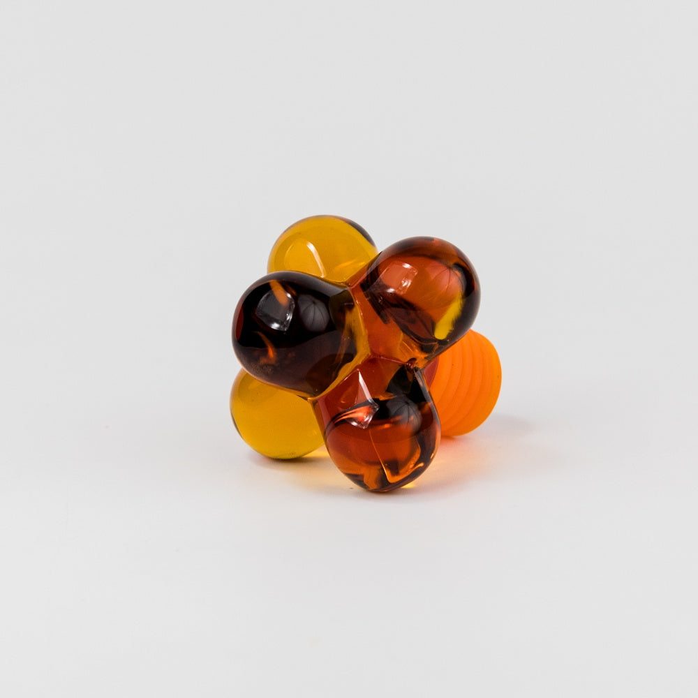 Amber glass bauble bottle stopper 
on a white background