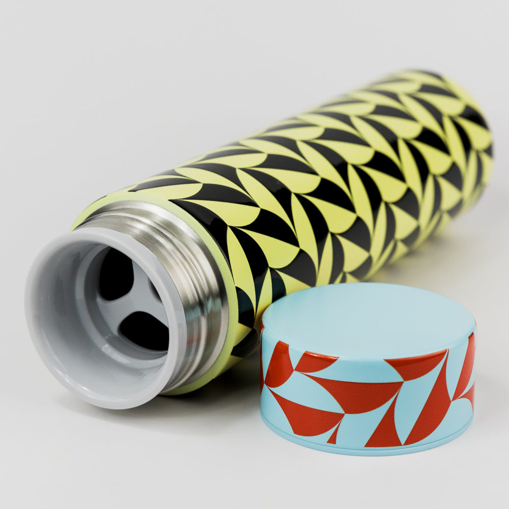 Cylindrical container with geometric pattern on a gray background
