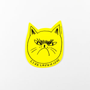 Yellow cat-shaped sticker with 'Live Laugh Love' text on a white background