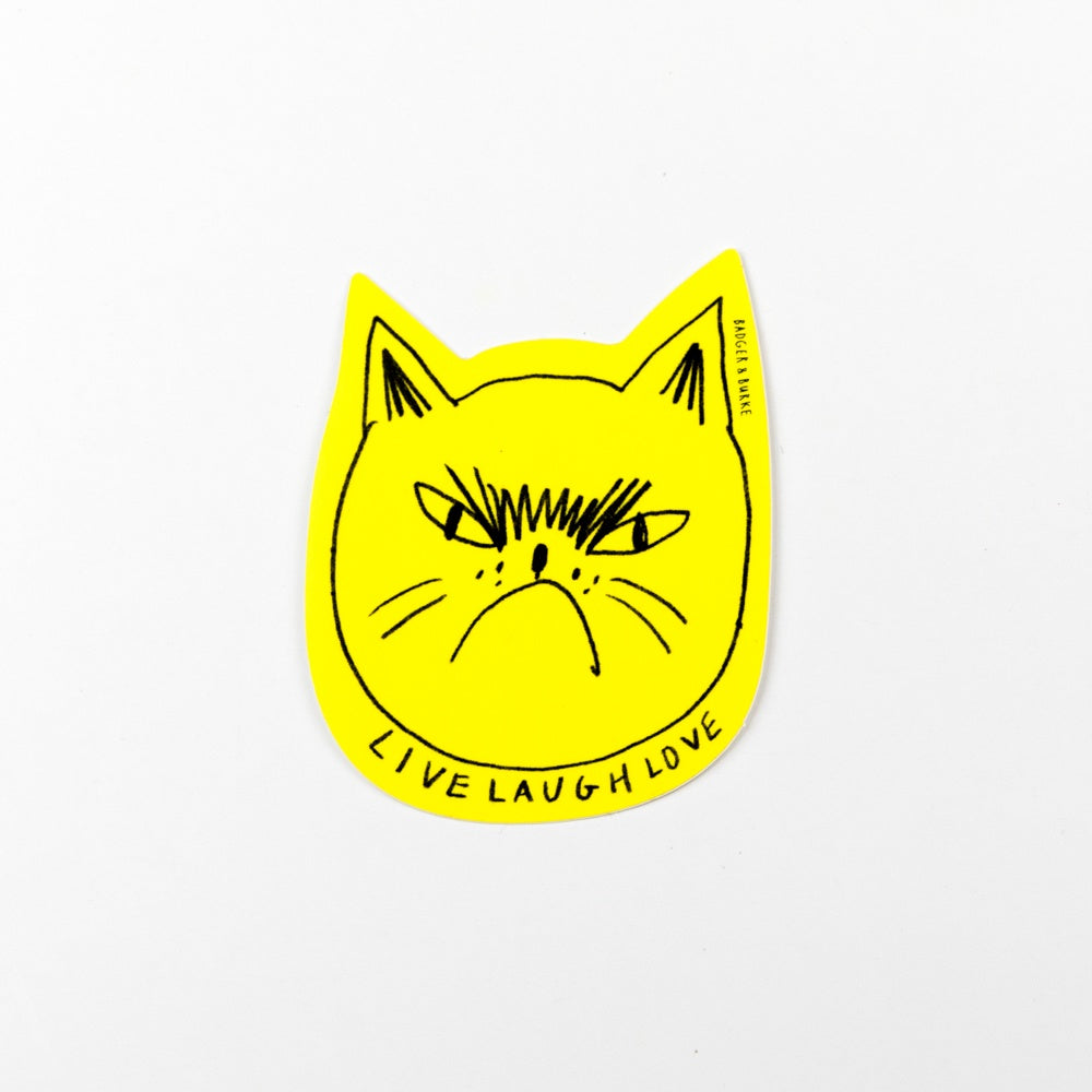 Yellow cat-shaped sticker with 'Live Laugh Love' text on a white background