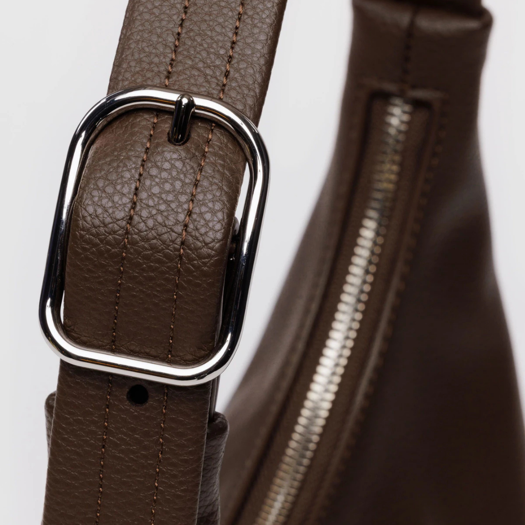 Brown leather belt with silver buckle on a white background