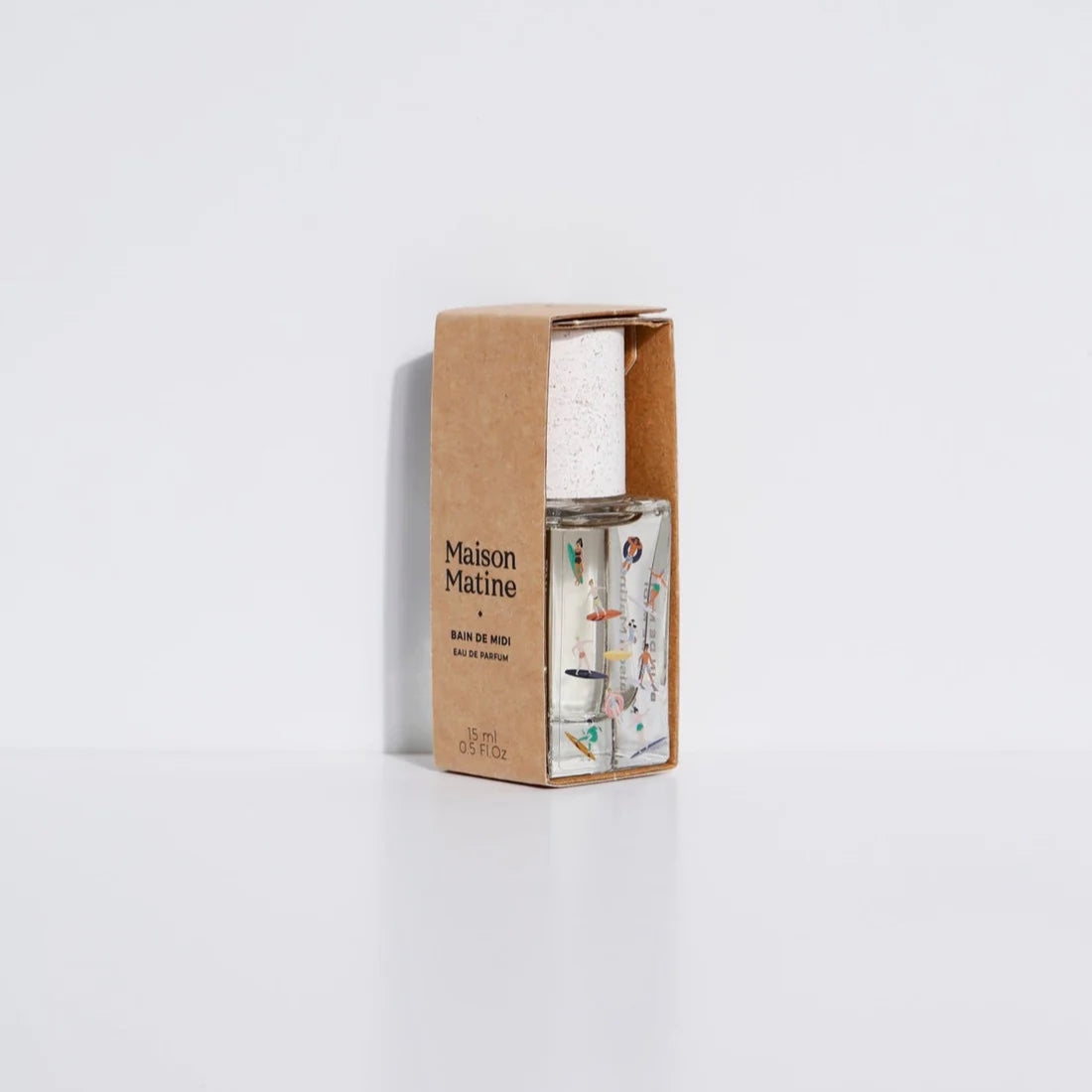 Clear perfume bottle with colorful design on a light gray background