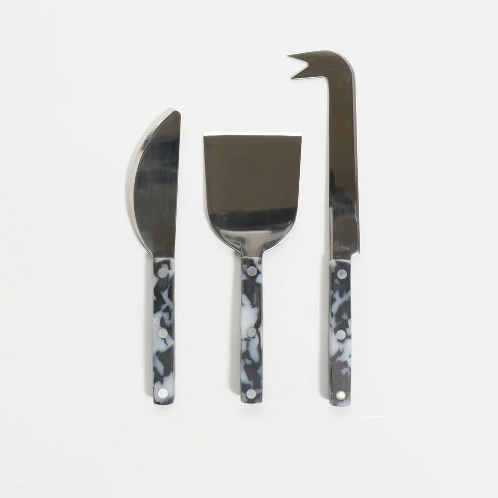 Three cheese knives with marble handles on a white background