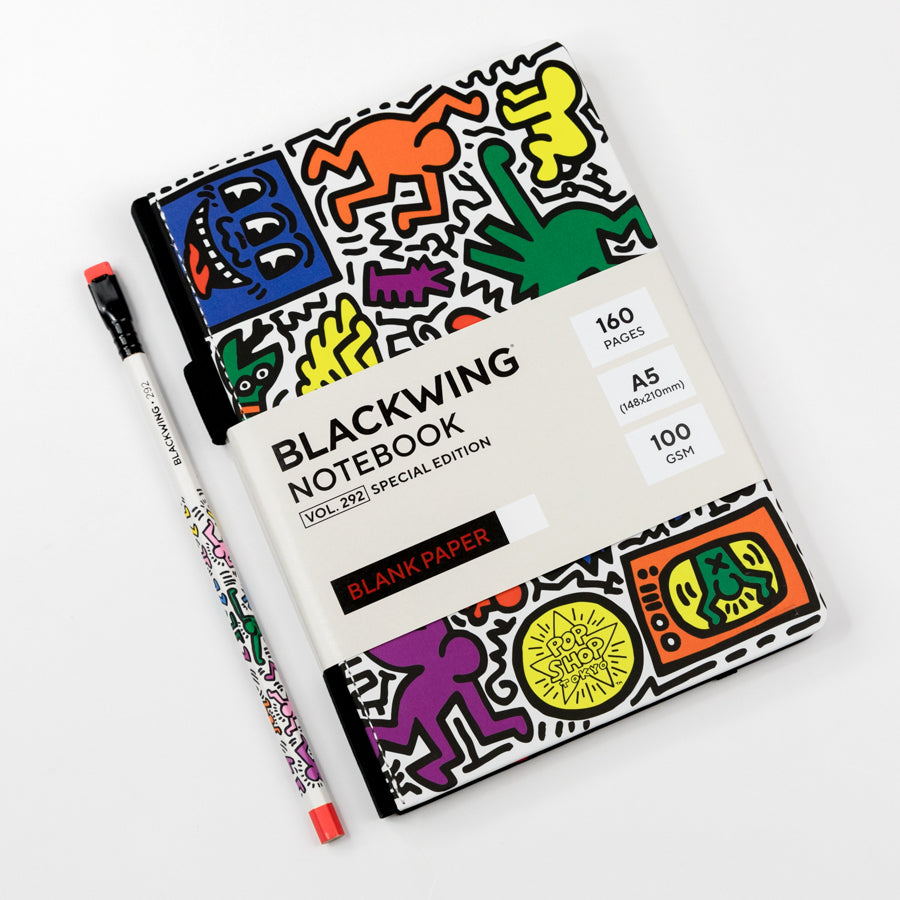 Blackwing notebook with colorful graphics and a pen on a white background