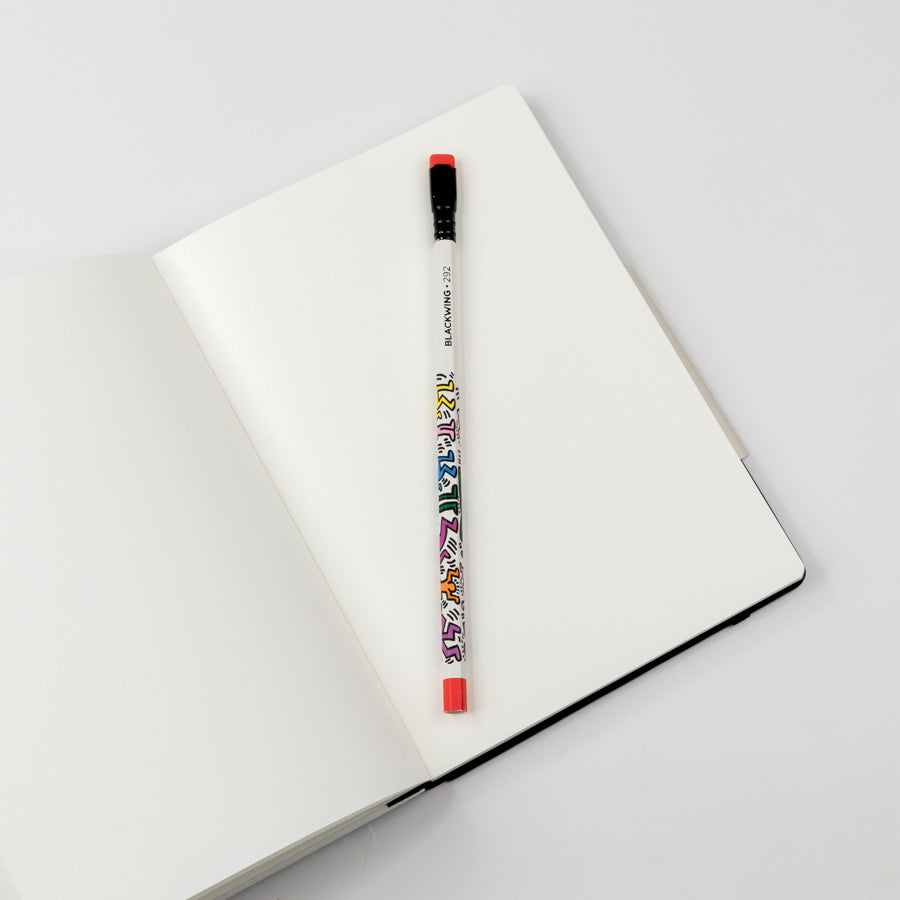 Colorful pencil on an open notebook with a white background
