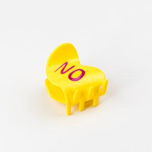Yellow chair-shaped object with 'NO' written on it against a white background