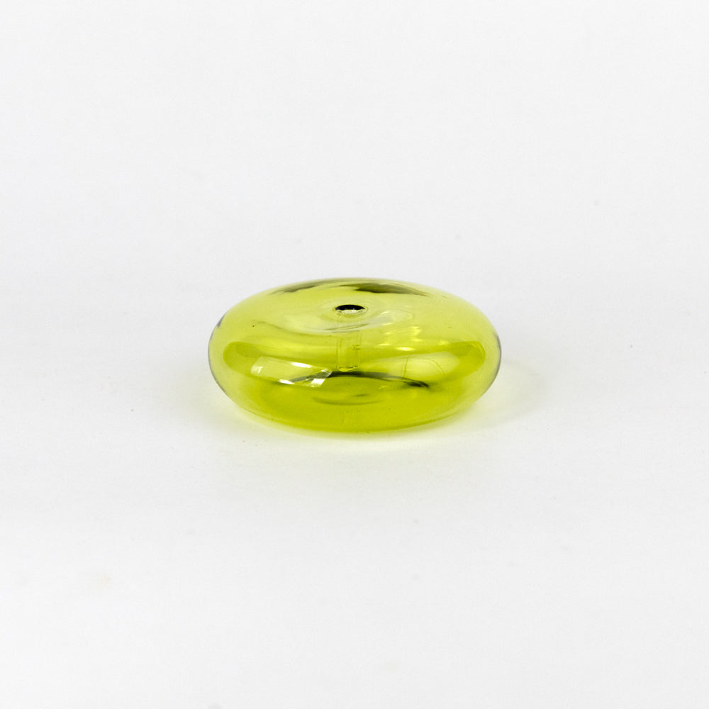 Incense stick in a green holder on a white background